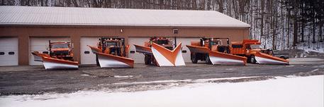 Picture of Town Garage with several snow plows